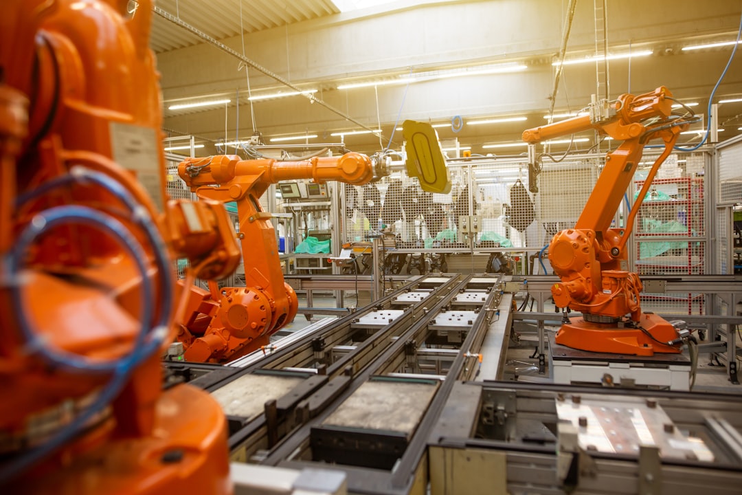 a factory filled with lots of orange machines a factory filled with lots of orange machines
